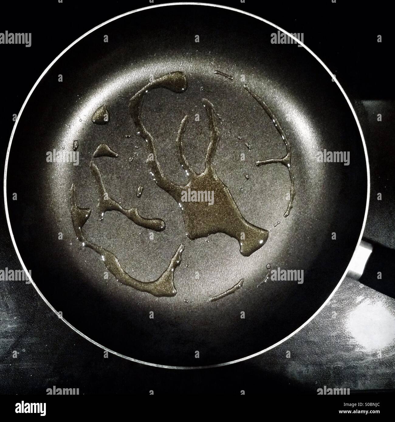 Olive oil being heated in a frying pan. - Smartphone Captured Stock Image