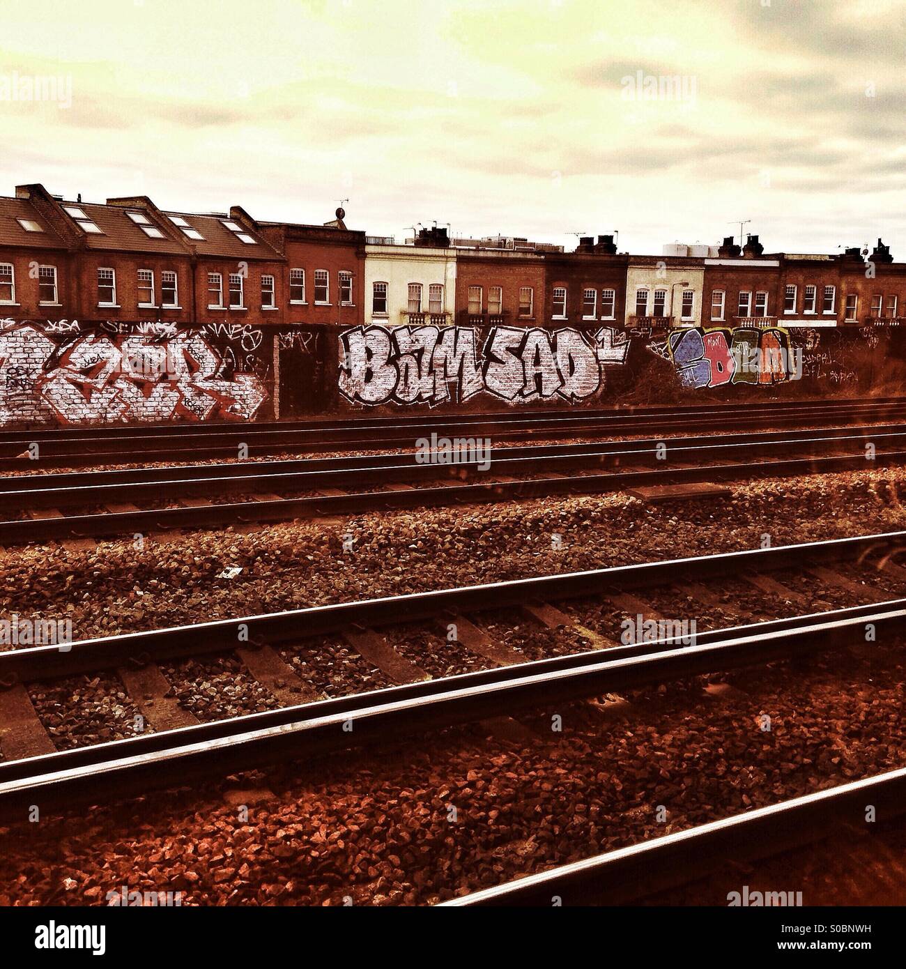 Railway tracks, buildings and trackside graffiti Stock Photo