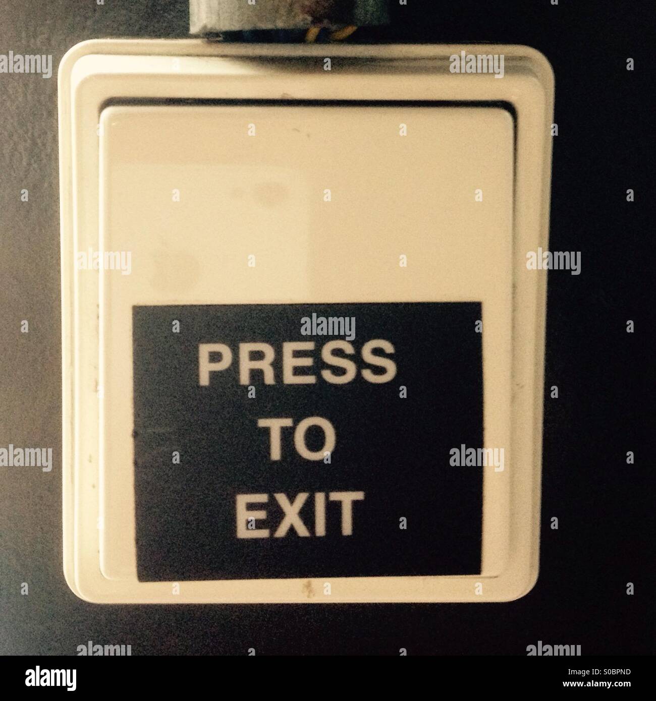 green emergency exit button to open door press here Stock Photo - Alamy