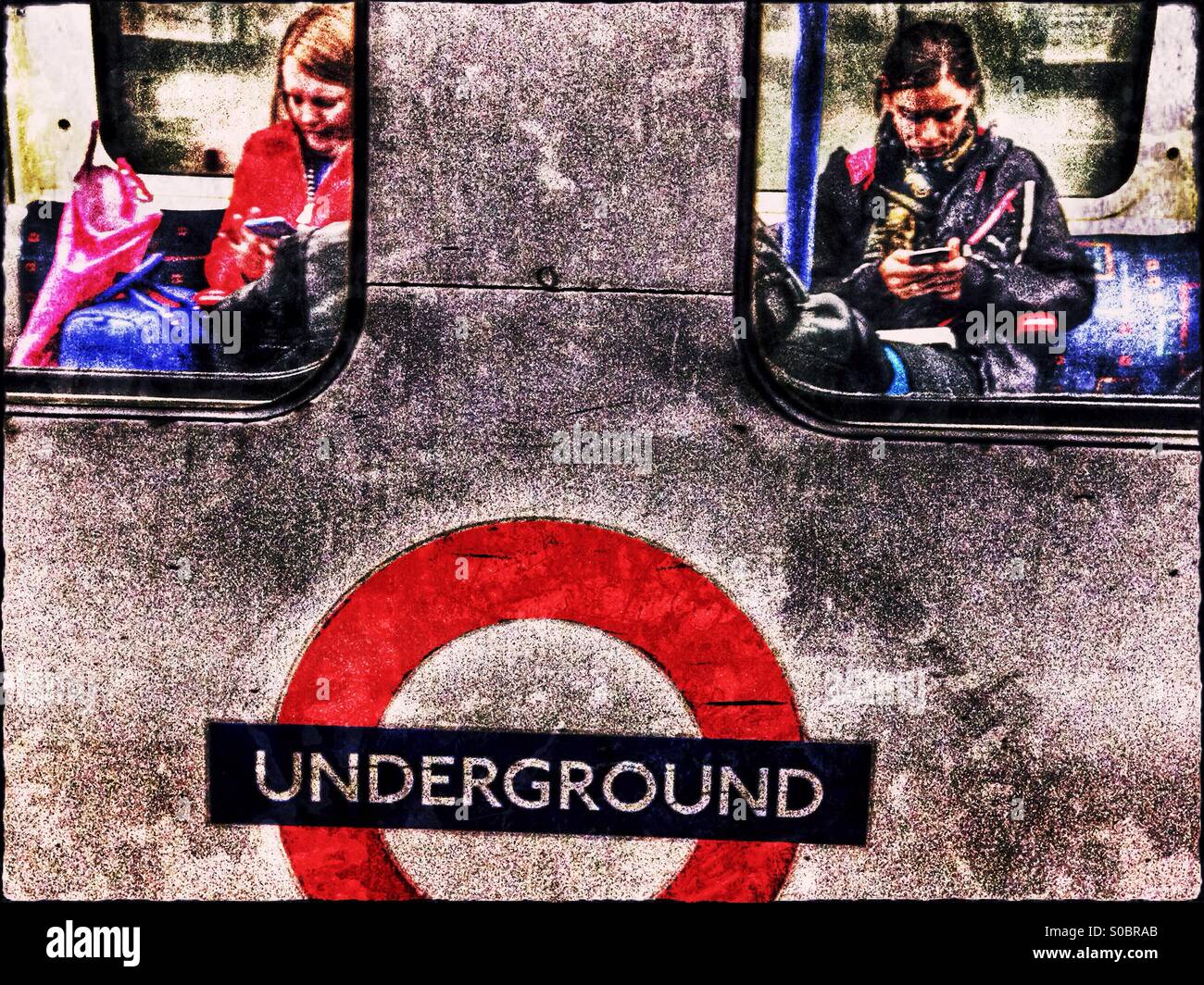 Women using smart phones on the tube, London, England, United Kingdom