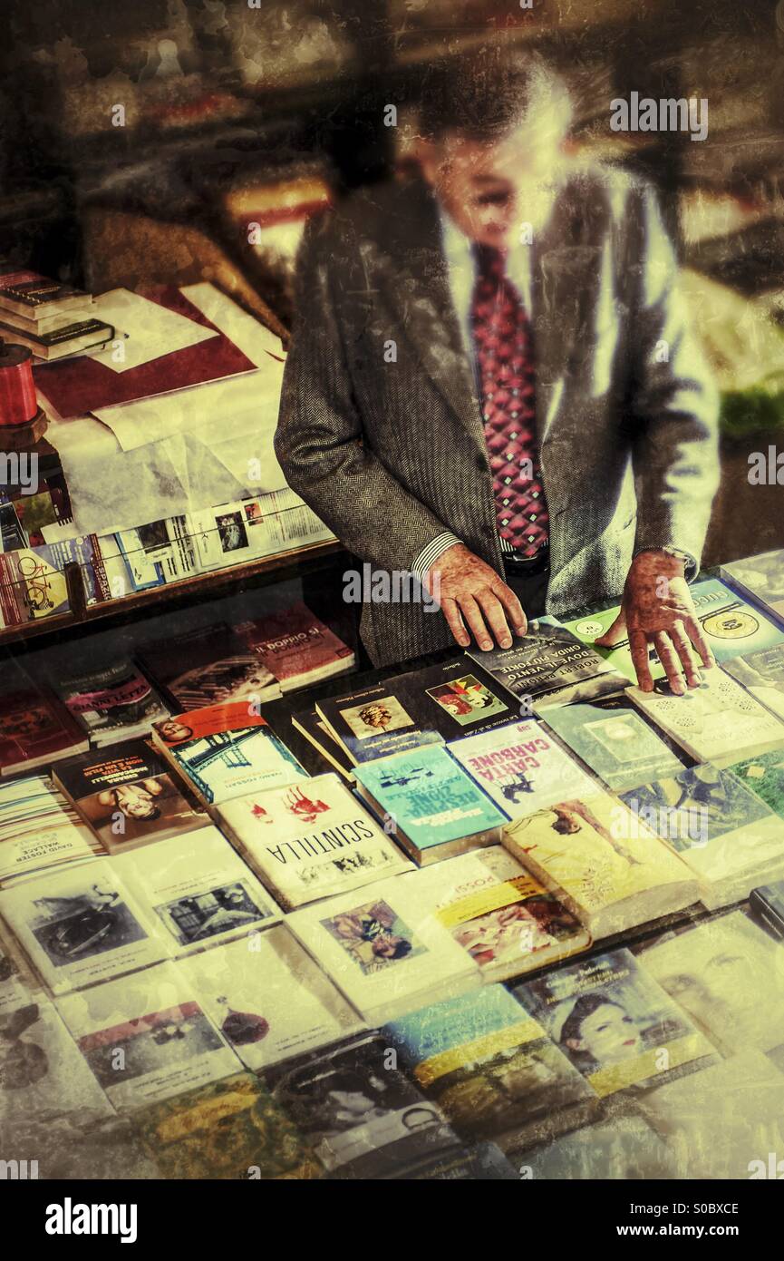 Man choosing a book in a bookstore - Smartphone Captured Stock Image