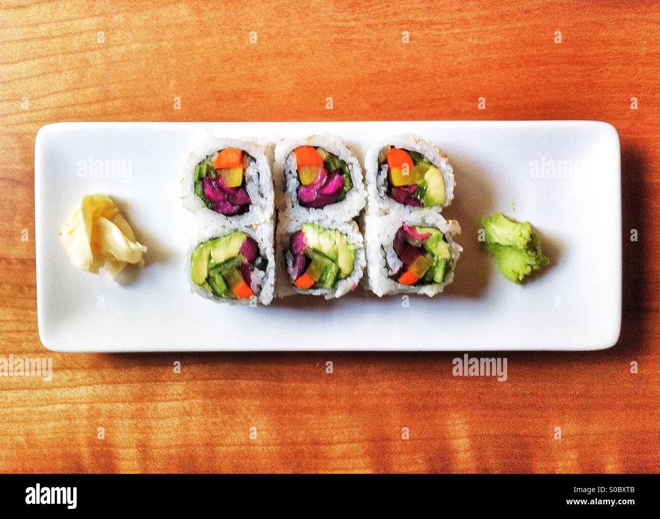 Vegetarian sushi rolls on long white plate - Smartphone Captured Stock Image