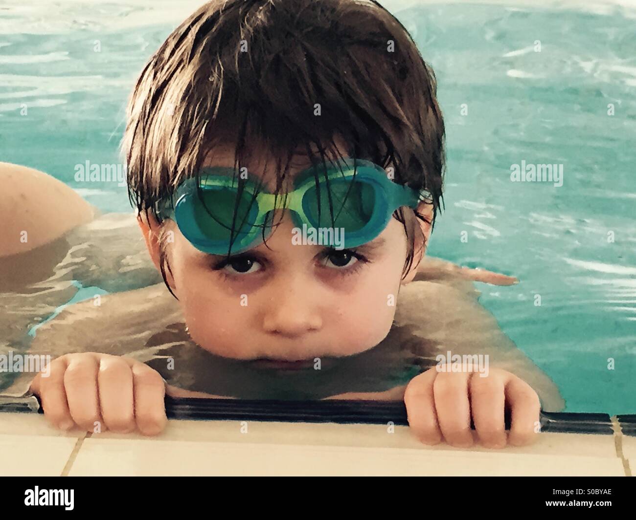 4 years old boy in swimming pool with swimming glasses Stock Photo Alamy