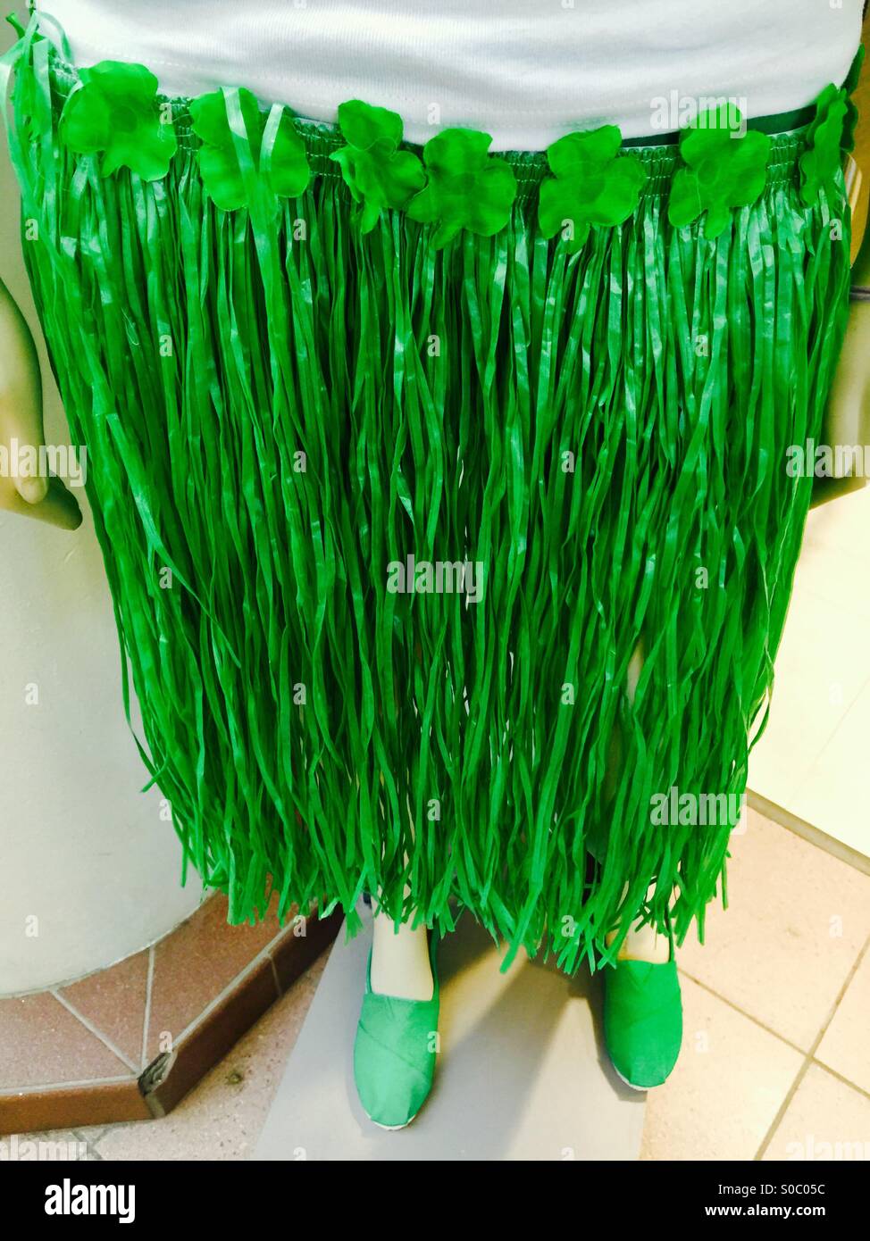 Green, skirt with shamrock flowers, iconically representing all things Irish, on display in a store window, Ontario, Canada. Stock Photo