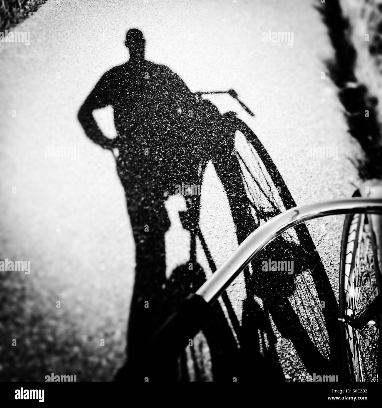 A shadow of a bike rider on a bike path. - Smartphone Captured Stock Image