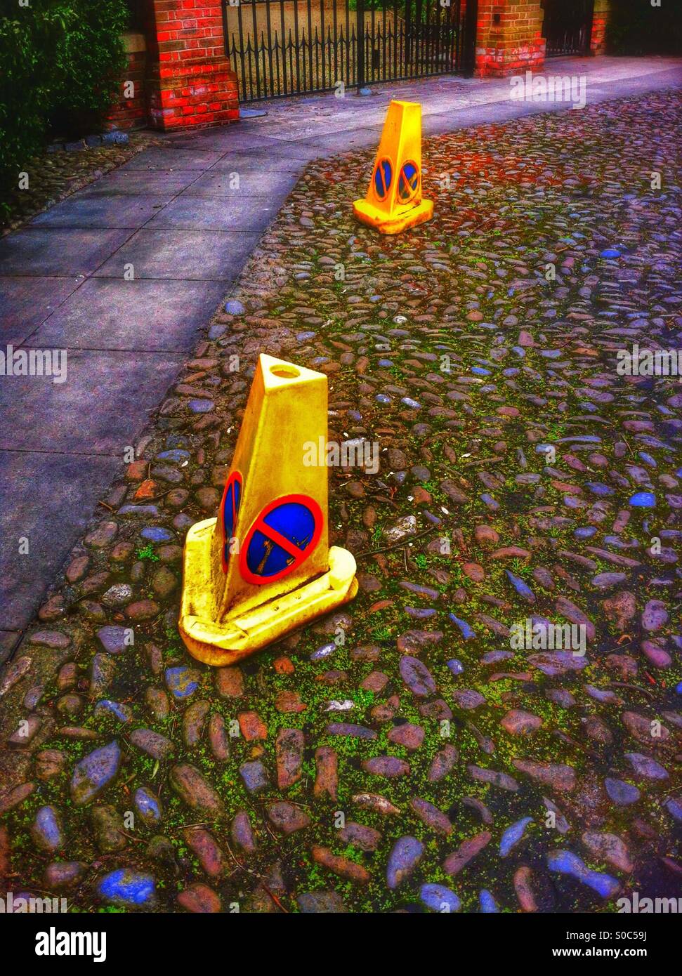 Police no waiting cones on cobbled street England UK - Smartphone Captured Stock Image