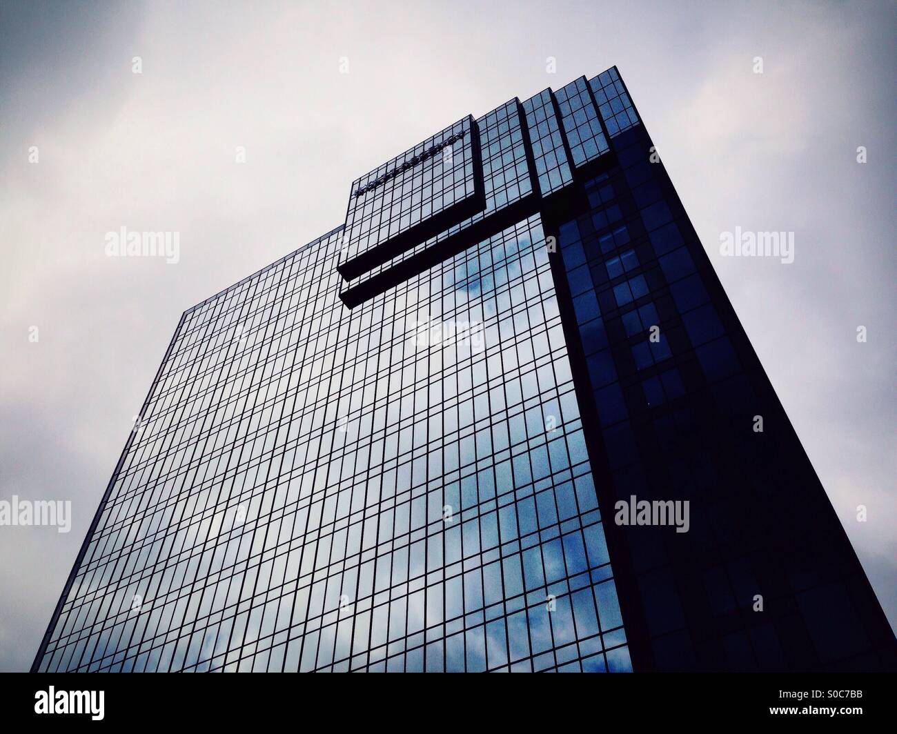 Moody tower block reflecting moody sky - Smartphone Captured Stock Image