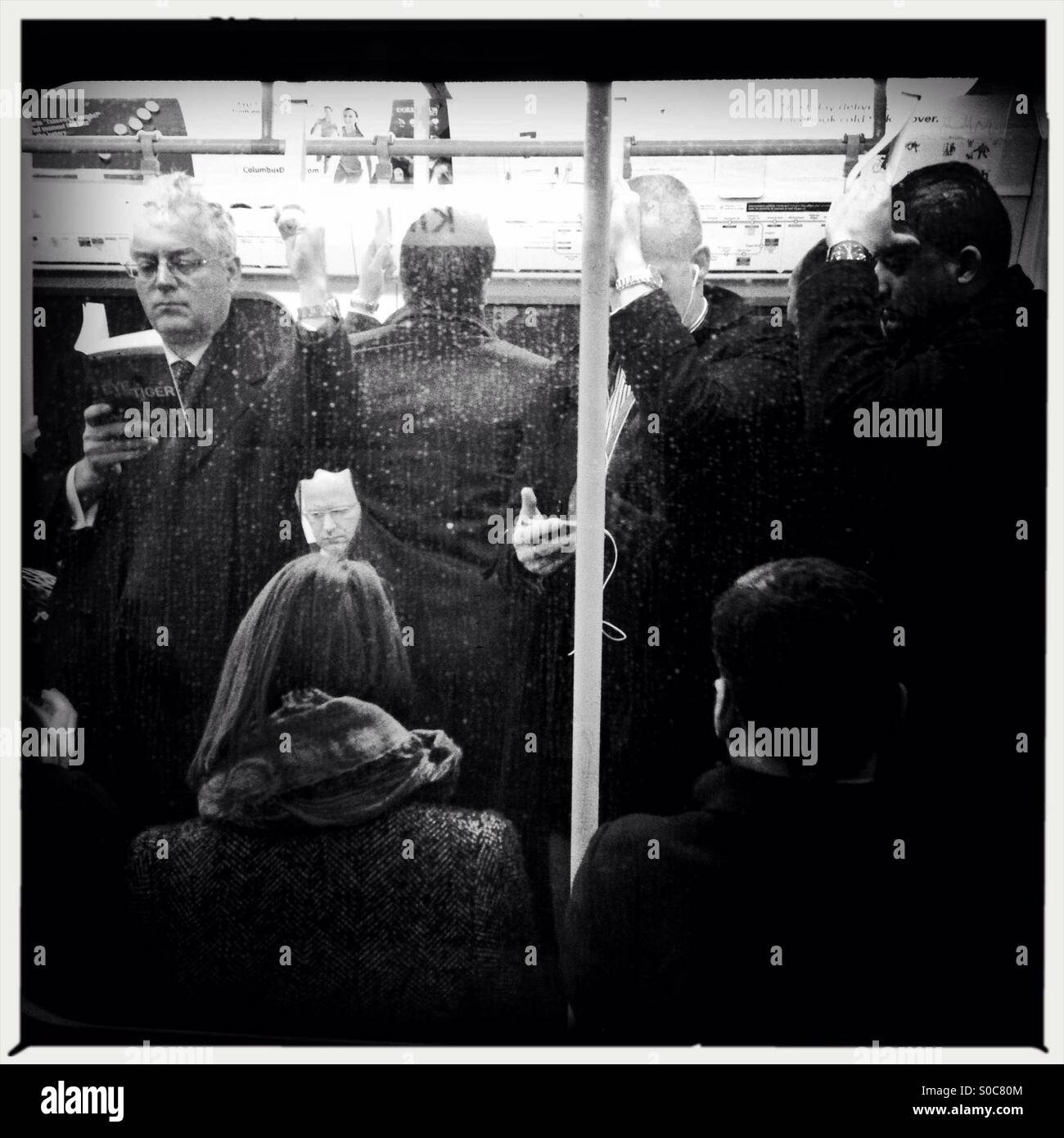 Commuters on London Underground  train - Smartphone Captured Stock Image