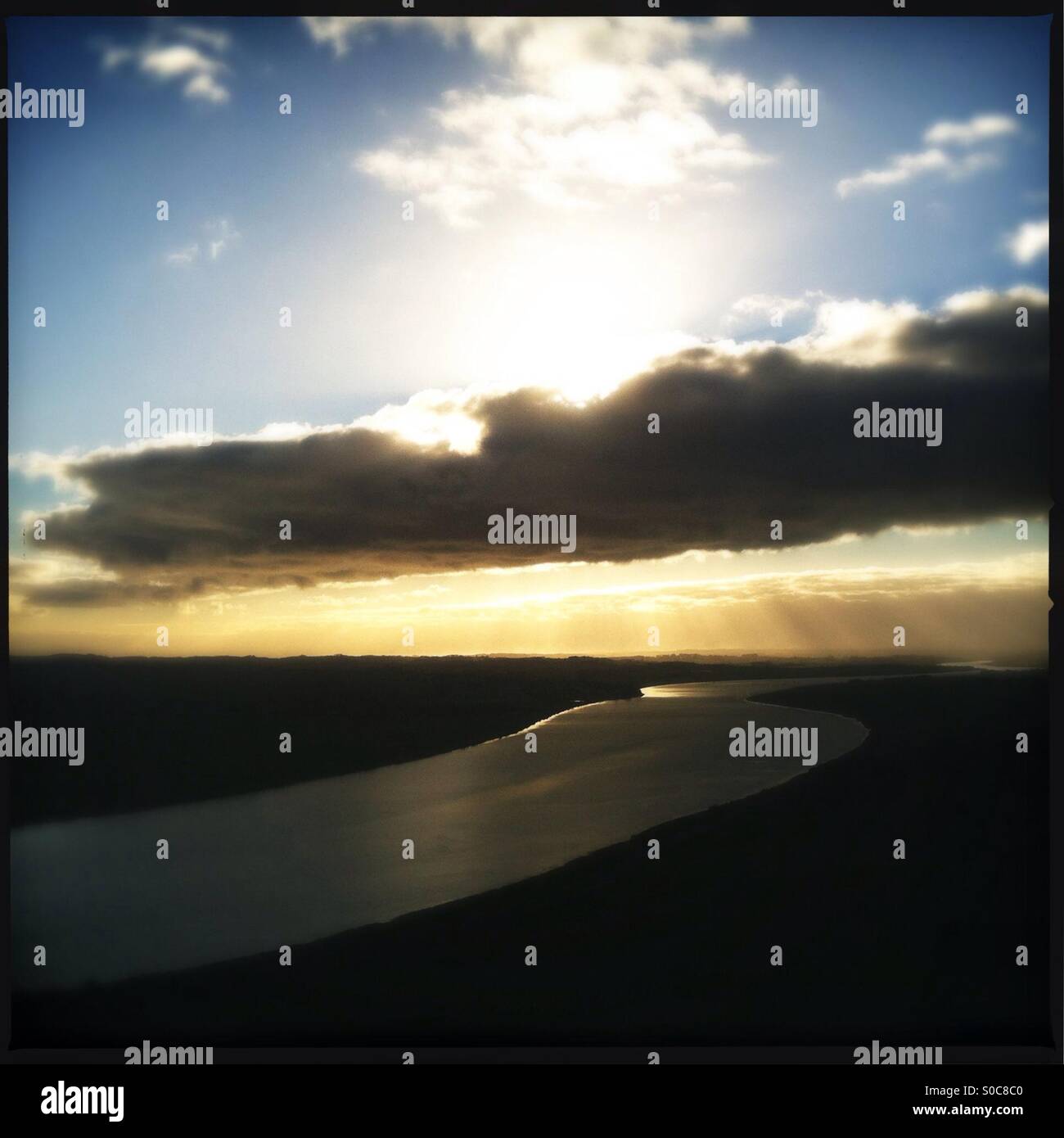 River running across landscape with cloud front - Smartphone Captured Stock Image