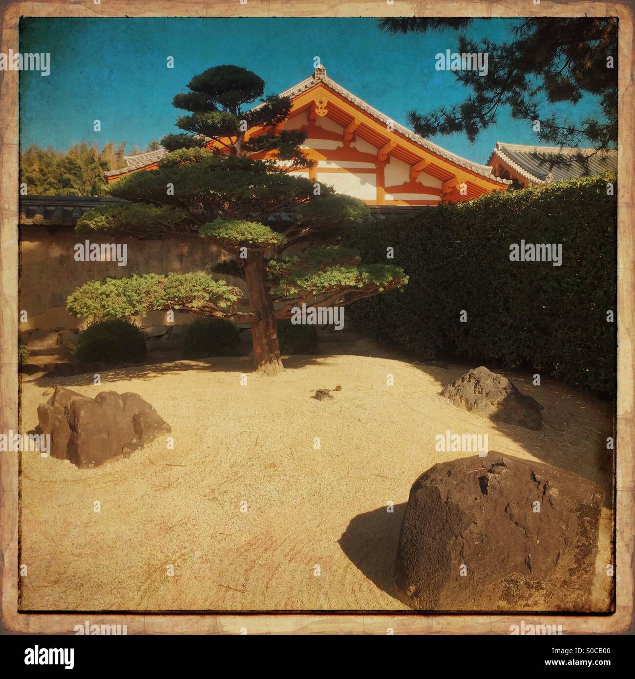 Karesansui, a dry landscape Japanese garden  composed entirely of rocks and sand, at Horyu-ji temple in Ikaruga, Nara Prefecture, Japan. World Heritage Site. Vintage paper frame. Stock Photo