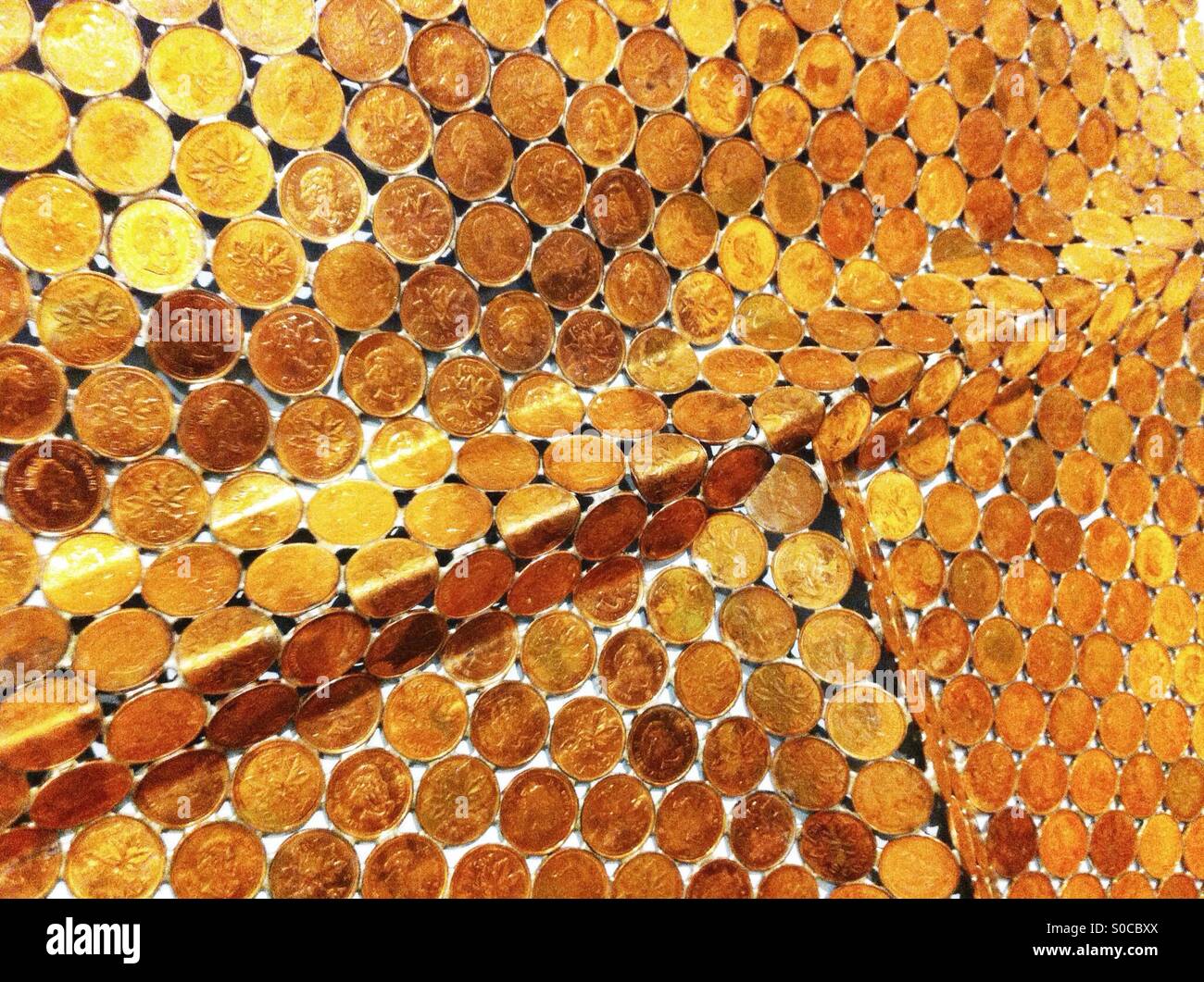 Golden copper Canadian pennies soldered together - Smartphone Captured Stock Image