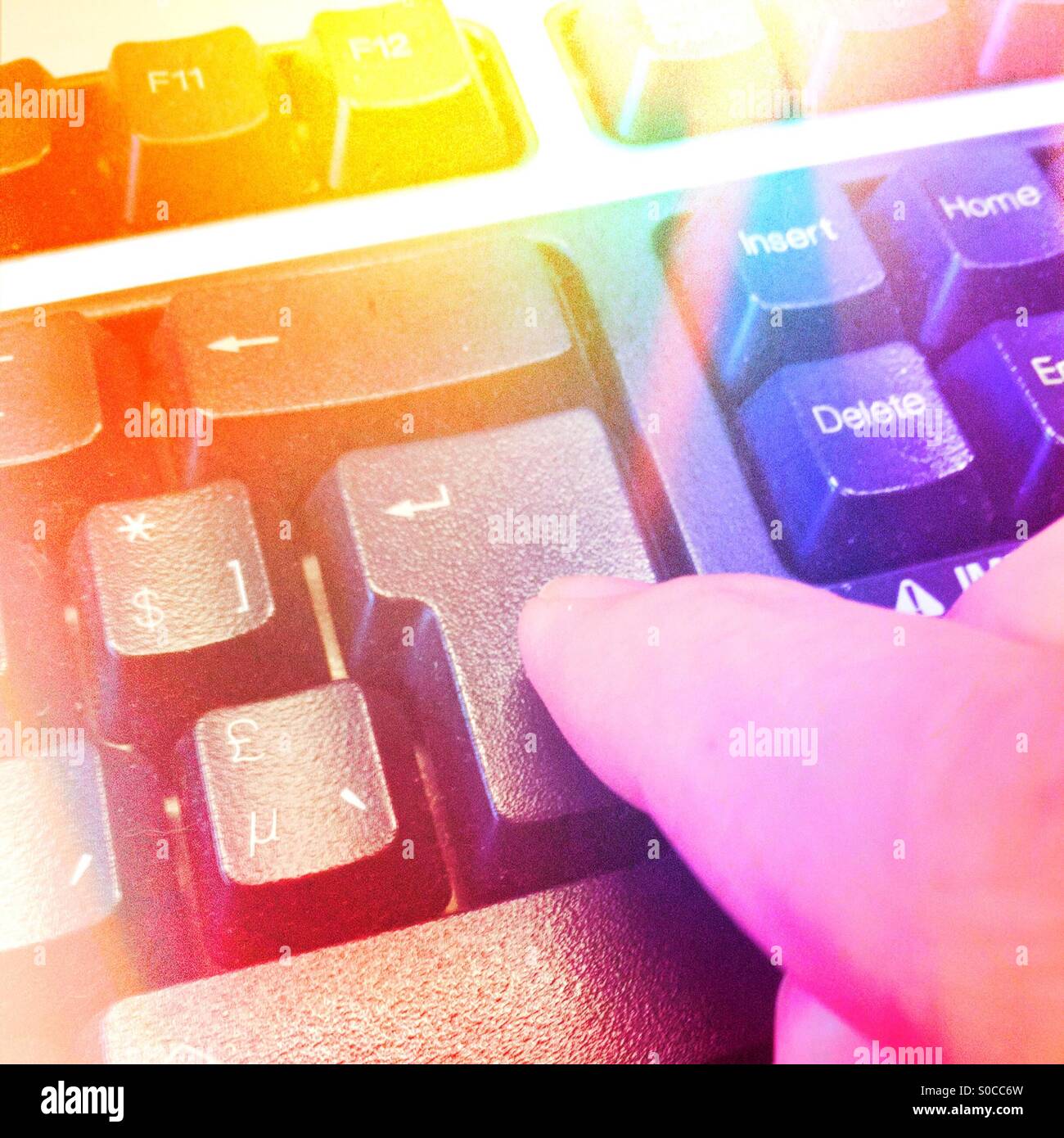 Finger pushing enter on keyboard - Smartphone Captured Stock Image