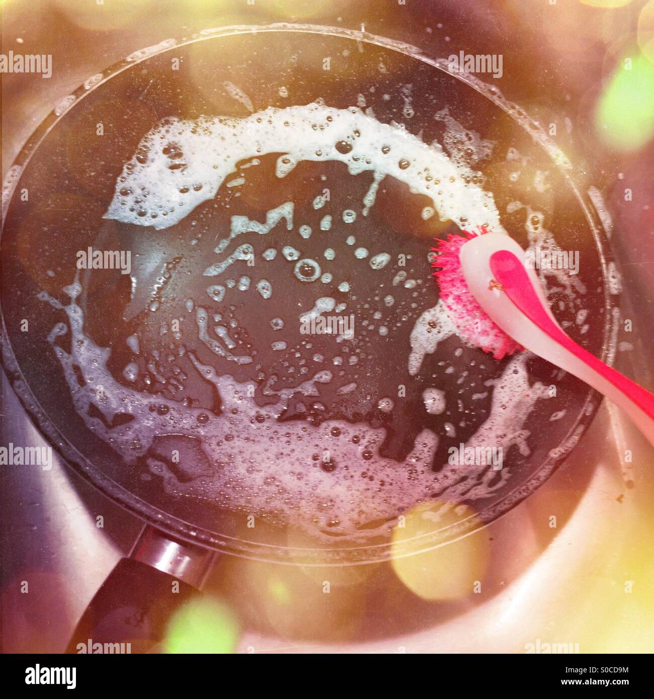 Cleaning cooking pan with brush - Smartphone Captured Stock Image