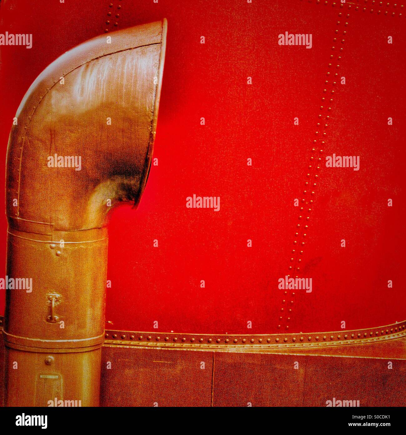 Bronze air vent against a ship's red funnel - Smartphone Captured Stock Image