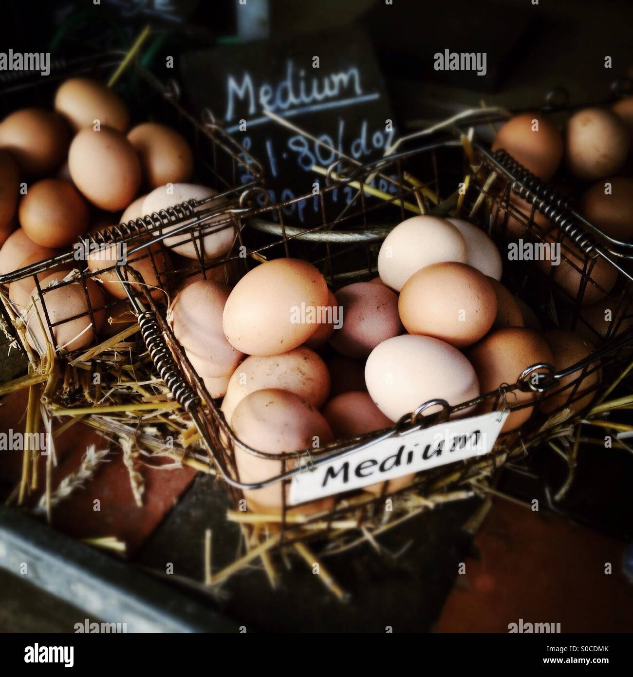 As sure as eggs is eggs. Baskets of fresh eggs on display in a farm shop. Stock Photo