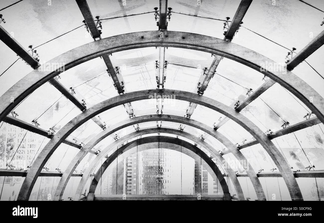 Covered walkway over the Calgary Ctrain tracks. Downtown Calgary, Alberta, Canada. - Smartphone Captured Stock Image