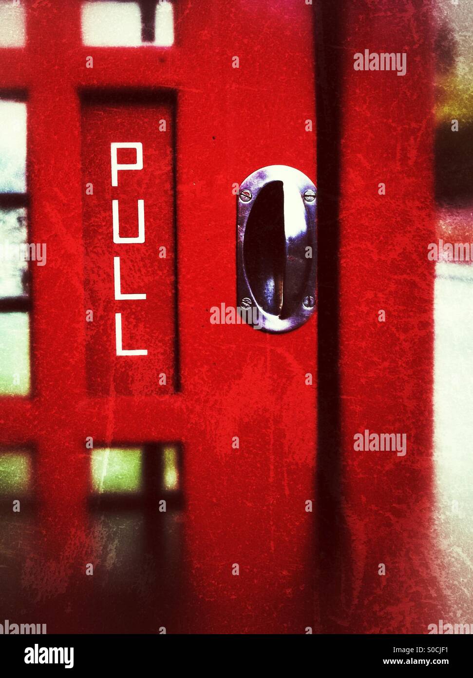 Red telephone box door handle England UK - Smartphone Captured Stock Image