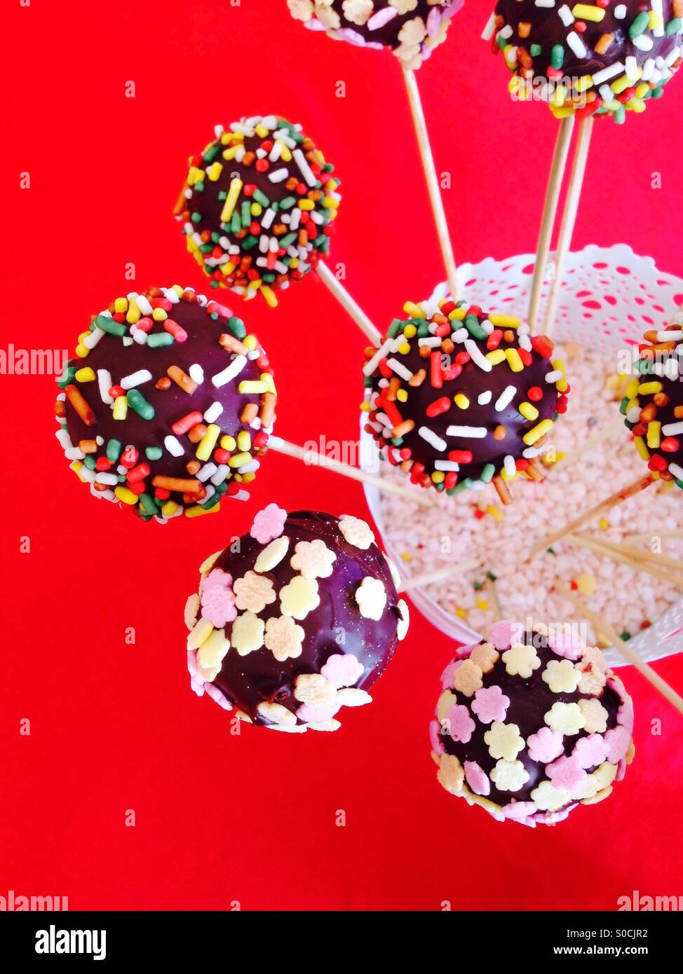 Colorful cakepops on red background Stock Photo