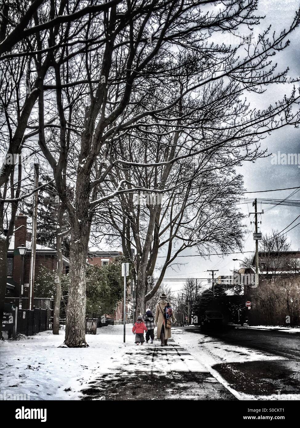 Mother and 2 kids walking in the street. - Smartphone Captured Stock Image