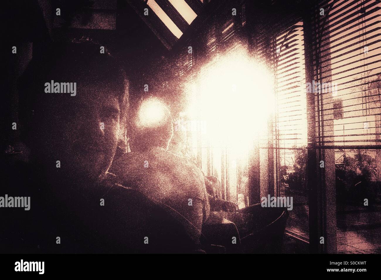 Selfie of a young man seated inside a restaurant against the sun - Smartphone Captured Stock Image