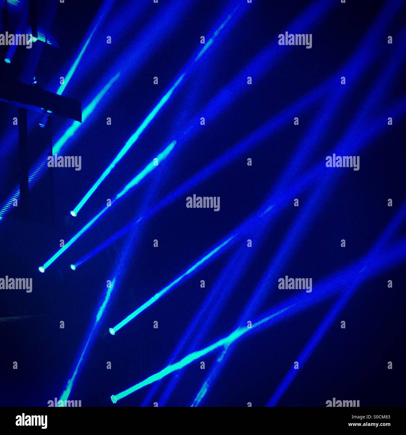 Blue laser lights at a music concert Stock Photo