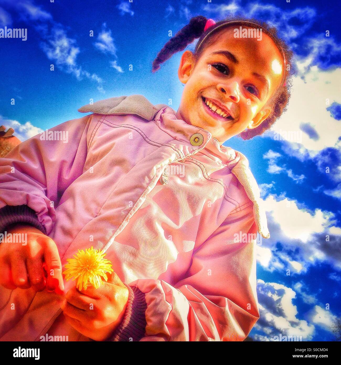 Little girl holding a dandelion Stock Photo - Alamy