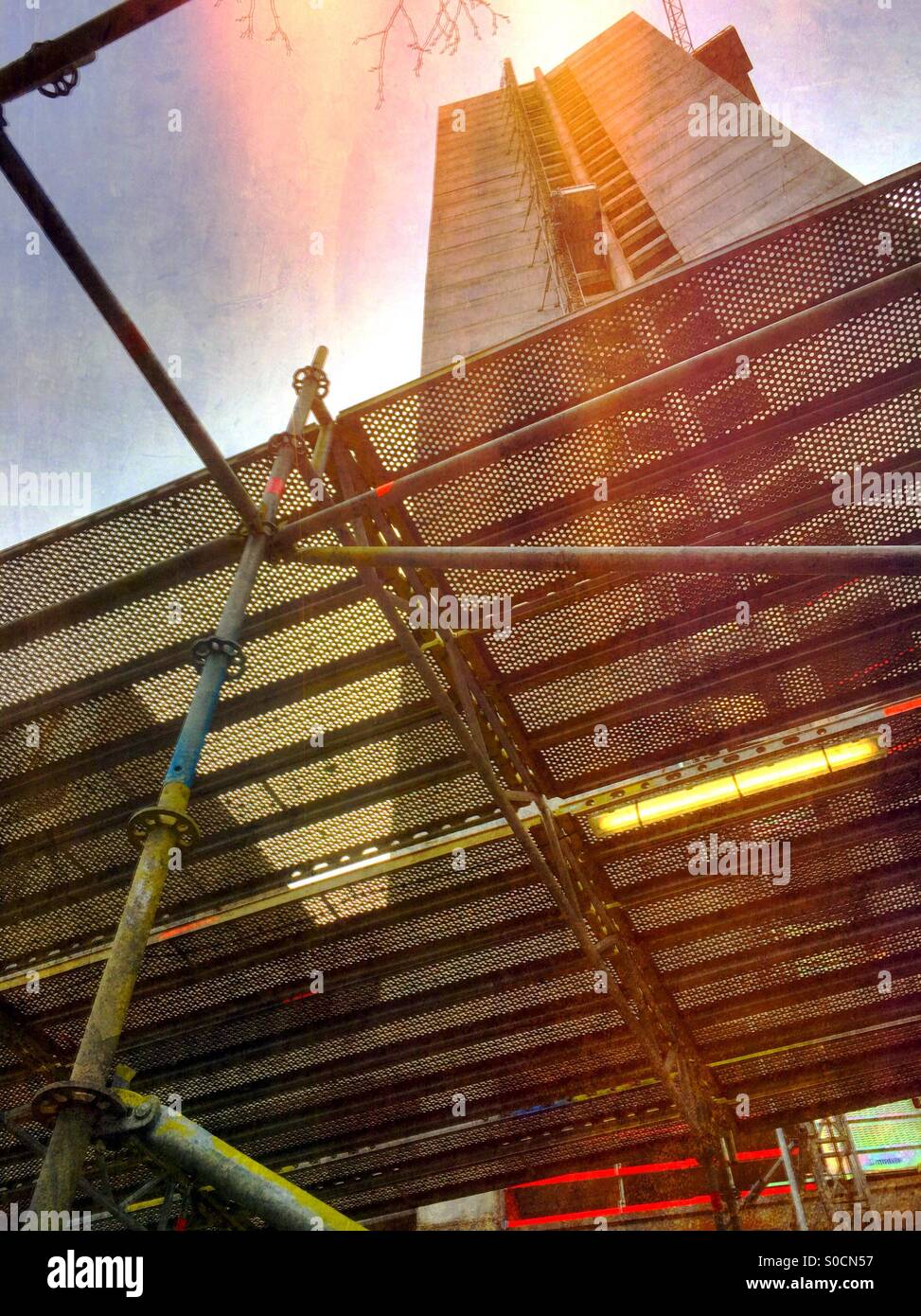 Office building under construction seen through protective scaffolding - Smartphone Captured Stock Image