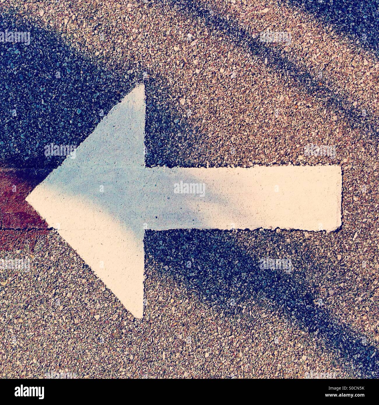 Arrow in stencil paint show turning left - Smartphone Captured Stock Image