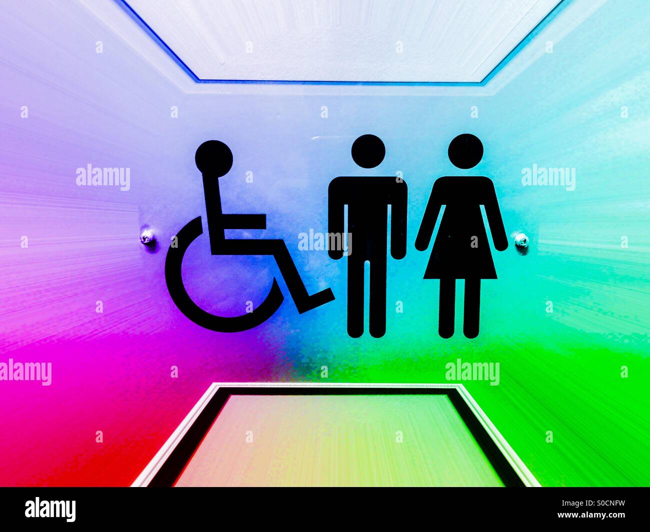 Rainbow. A colourful sign, using universal symbols, designed to convey inclusivity. Here, on a toilet door, a washroom for all — male, female, mobility-challenged — anyone, really. - Smartphone Captured Stock Image