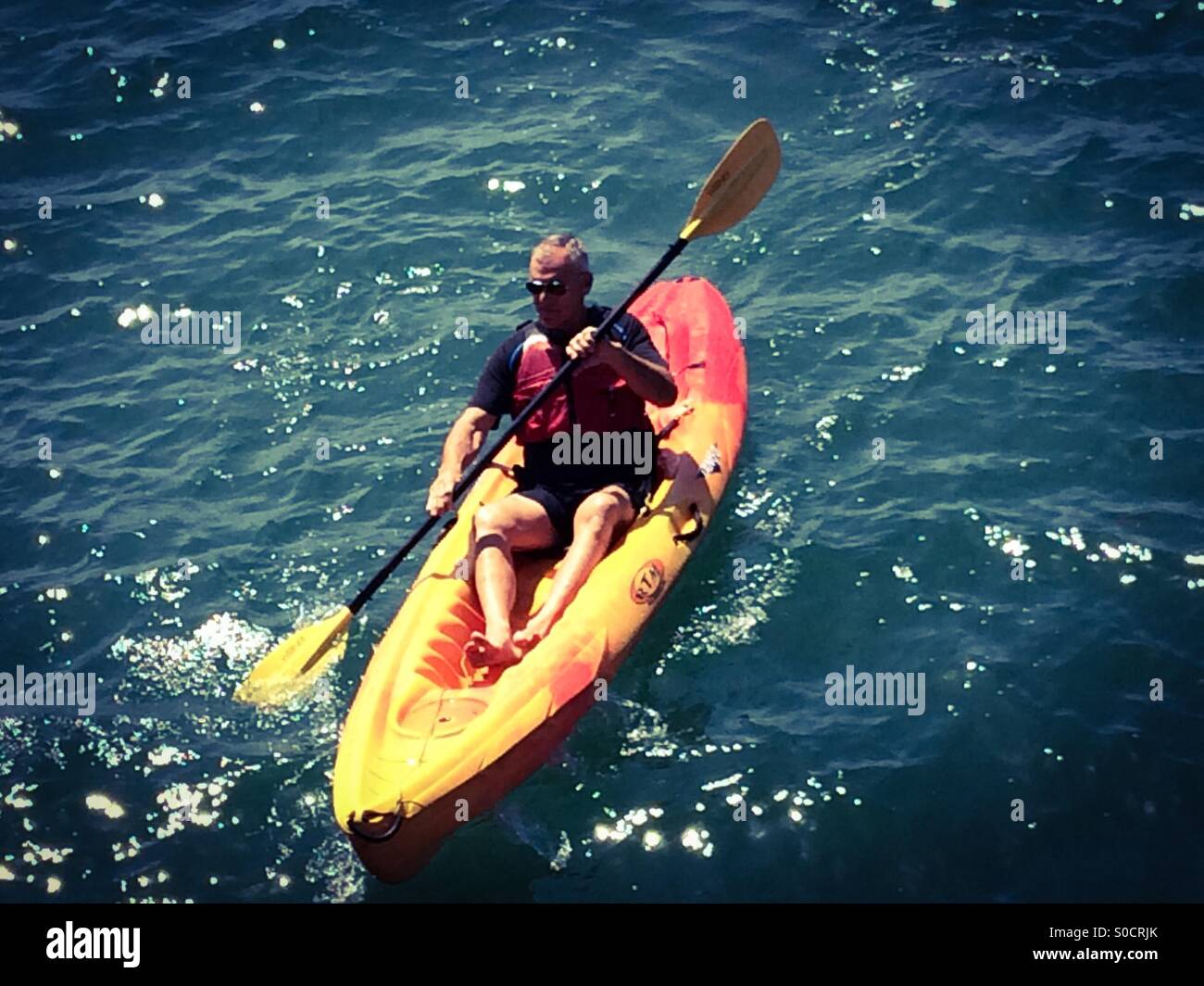 Older man kayaks in Santa Barbara, California USA Stock Photo