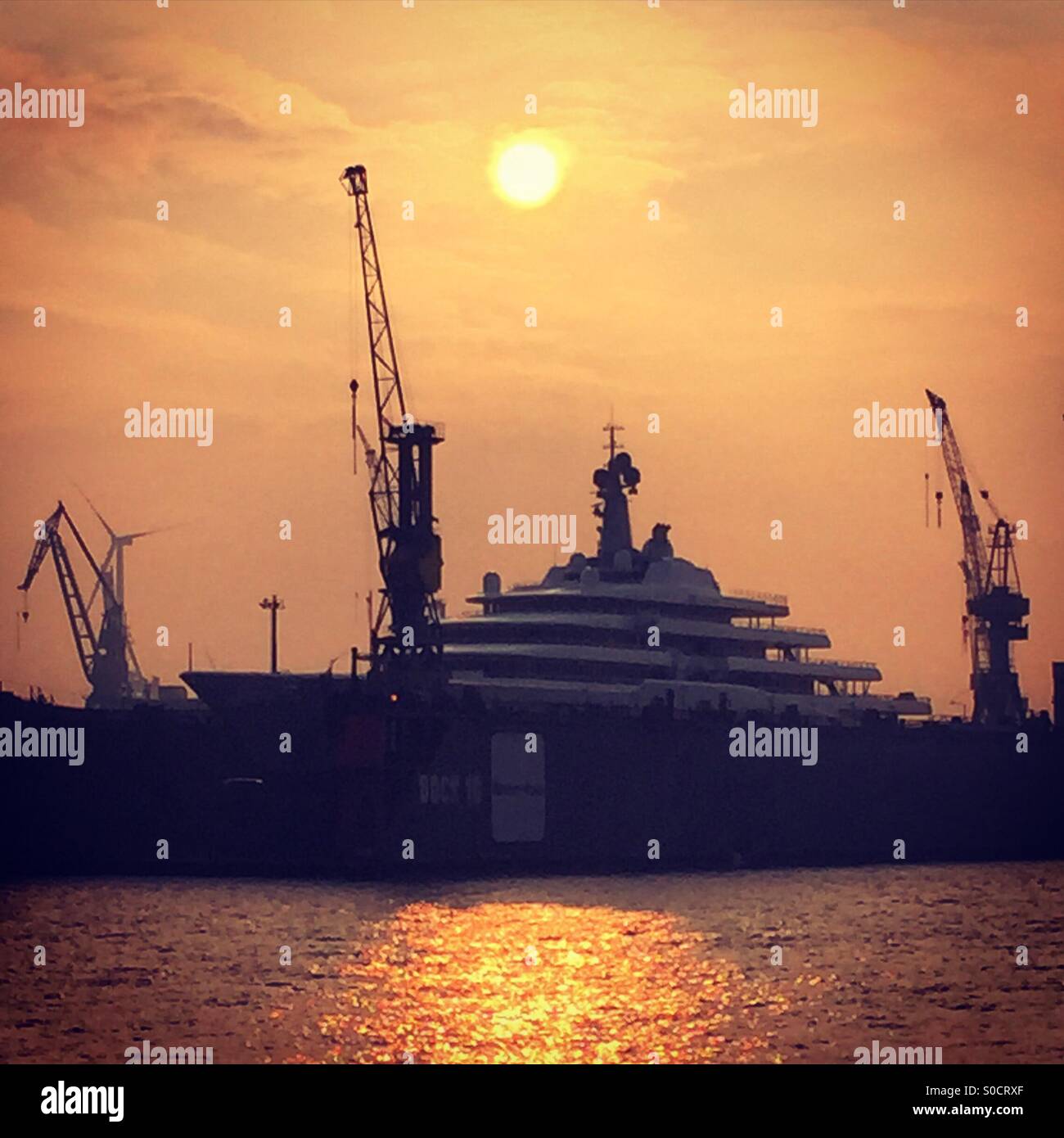 Sunset over a luxury yacht in Hamburg harbour Stock Photo