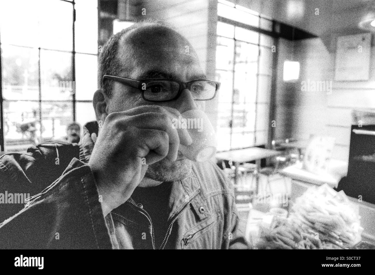 Worker hacking an espresso in the train station bar , early in the morning. - Smartphone Captured Stock Image