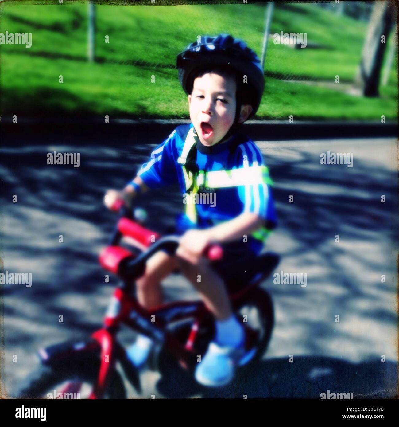 Boy riding a bicycle on the street Stock Photo