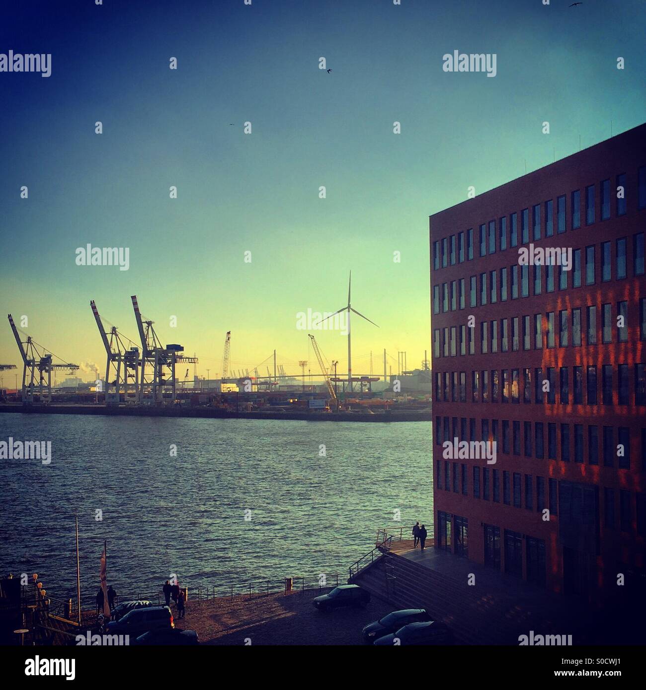 Looking out over Hamburg harbour at sunset Stock Photo