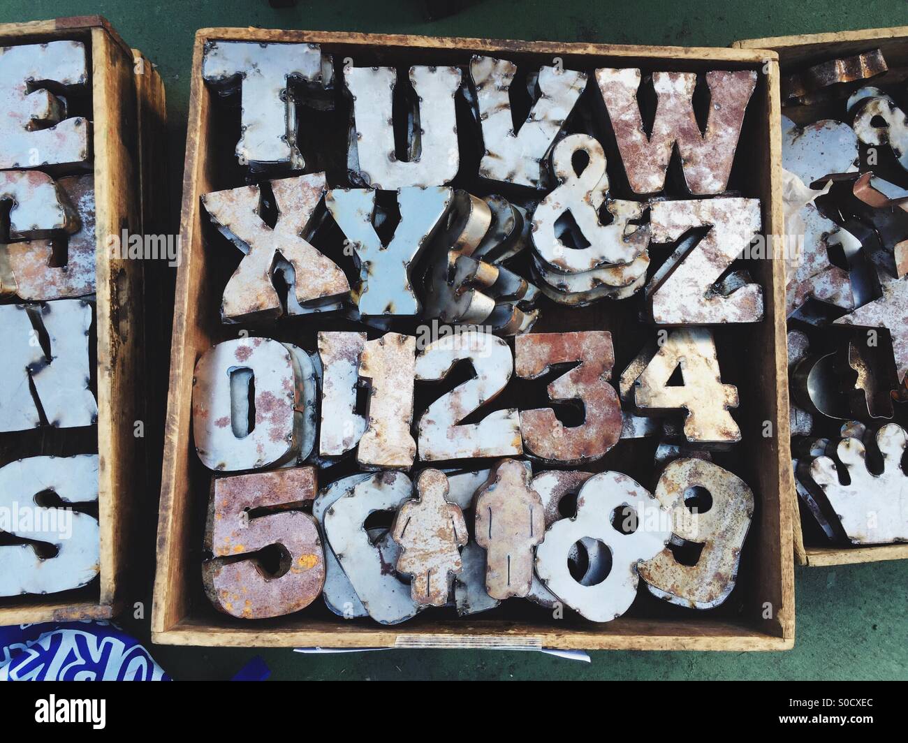Metal letters, numbers and figures are for sale at a flea market Stock