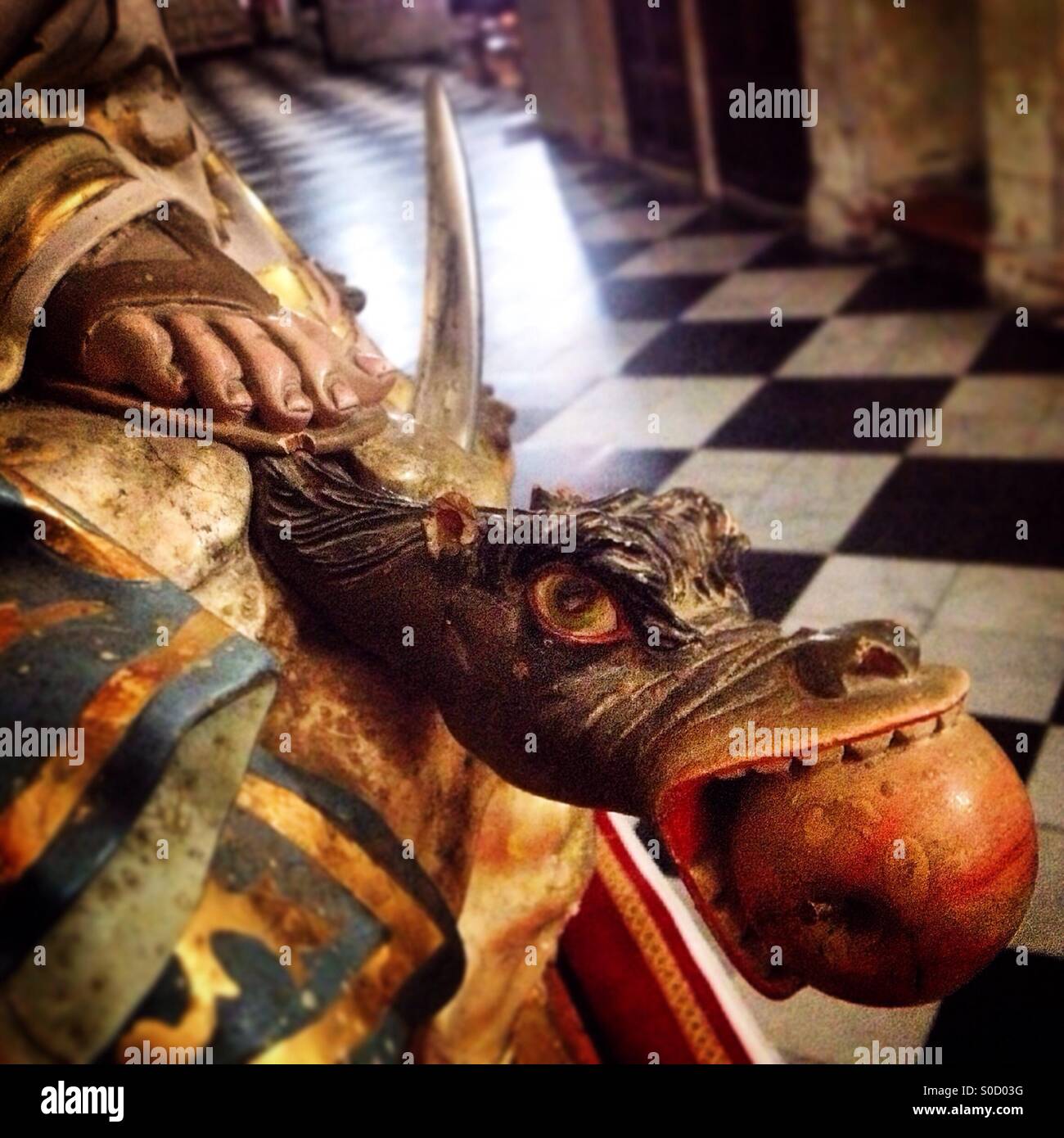 The feet of the Immaculate Conception of the Virgin Mary treading a dragon eating an apple in the Santa Maria Basilica, Arcos de la Frontera, Sierra de Cadiz, Andalusia,Spain - Smartphone Captured Stock Image
