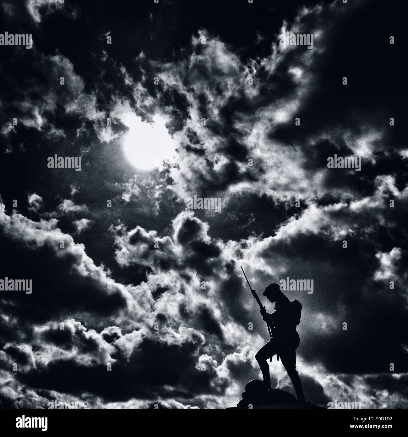 Statue of soldier in silhouette against simulated moonlight (Chorley Pals memorial in Chorley Lancashire) - Smartphone Captured Stock Image