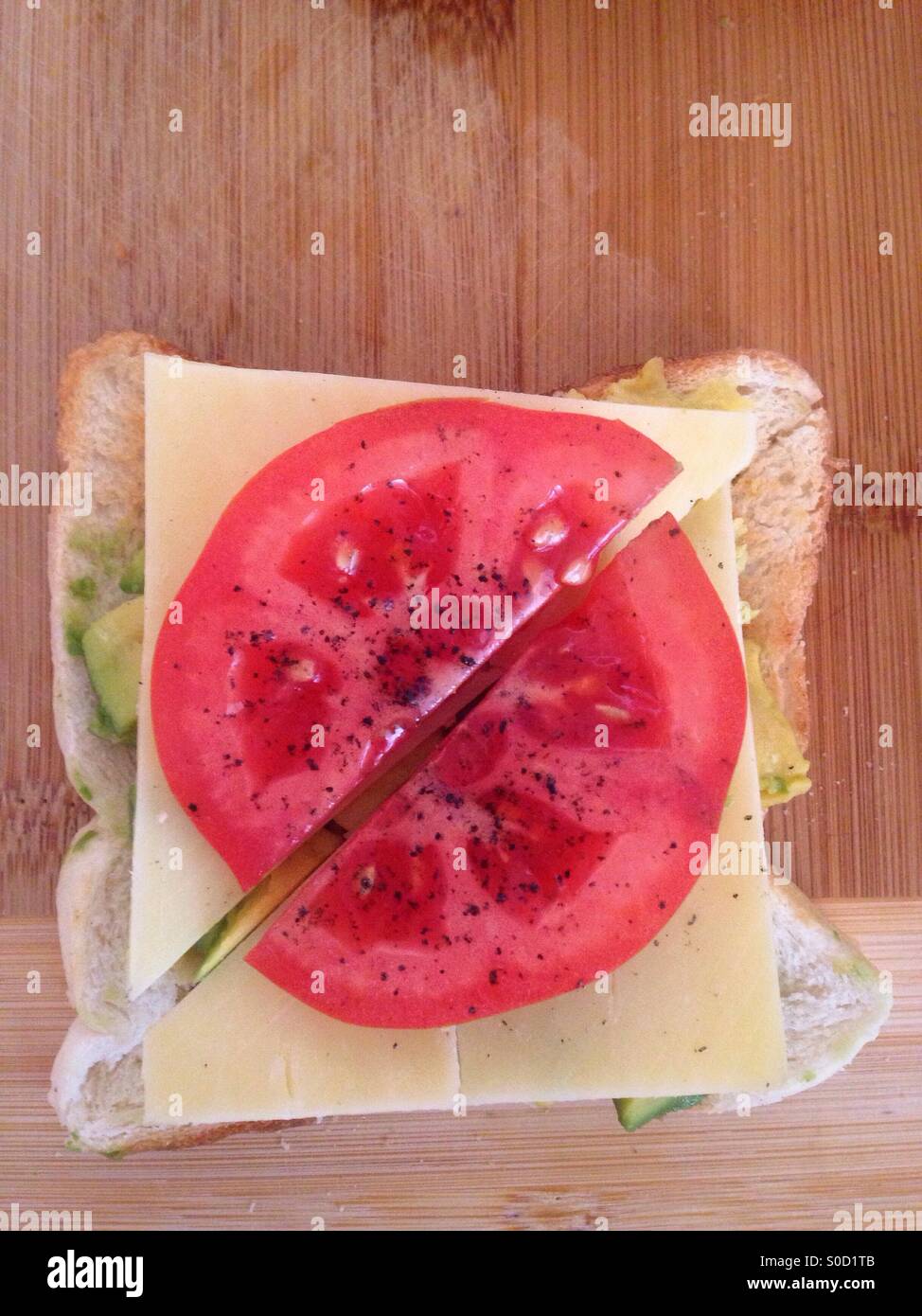 Healthy snack, made of bread, avocado, cheddar, tomato and pepper. - Smartphone Captured Stock Image