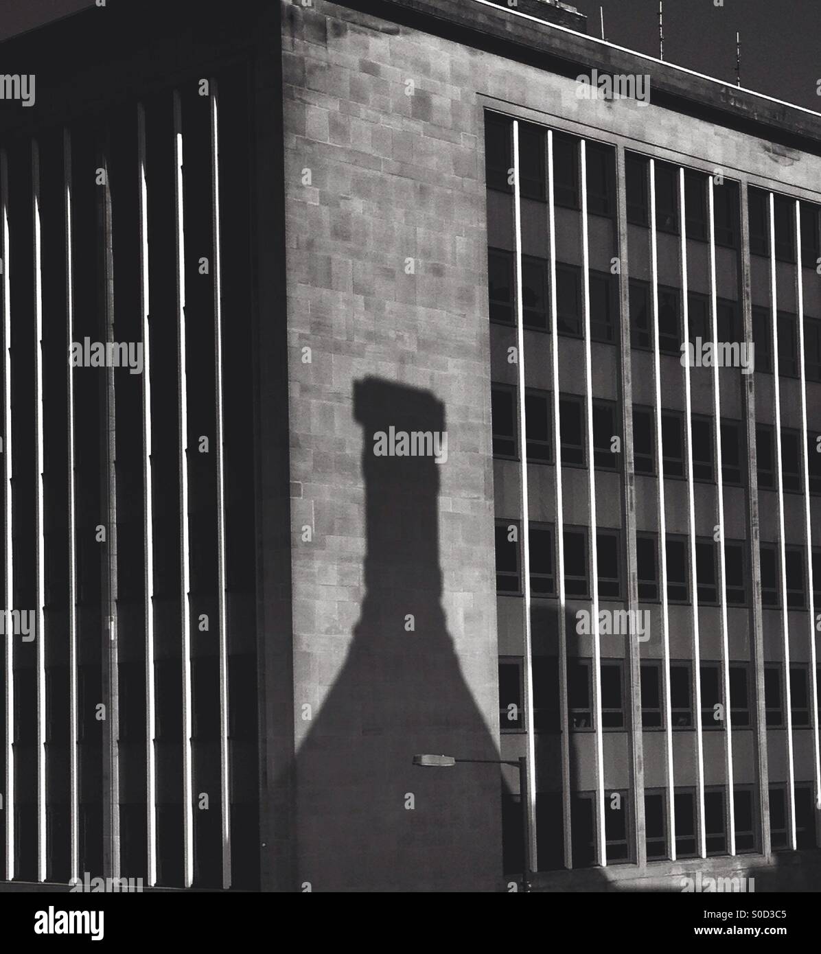 Bottle shaped shadow on building Stock Photo
