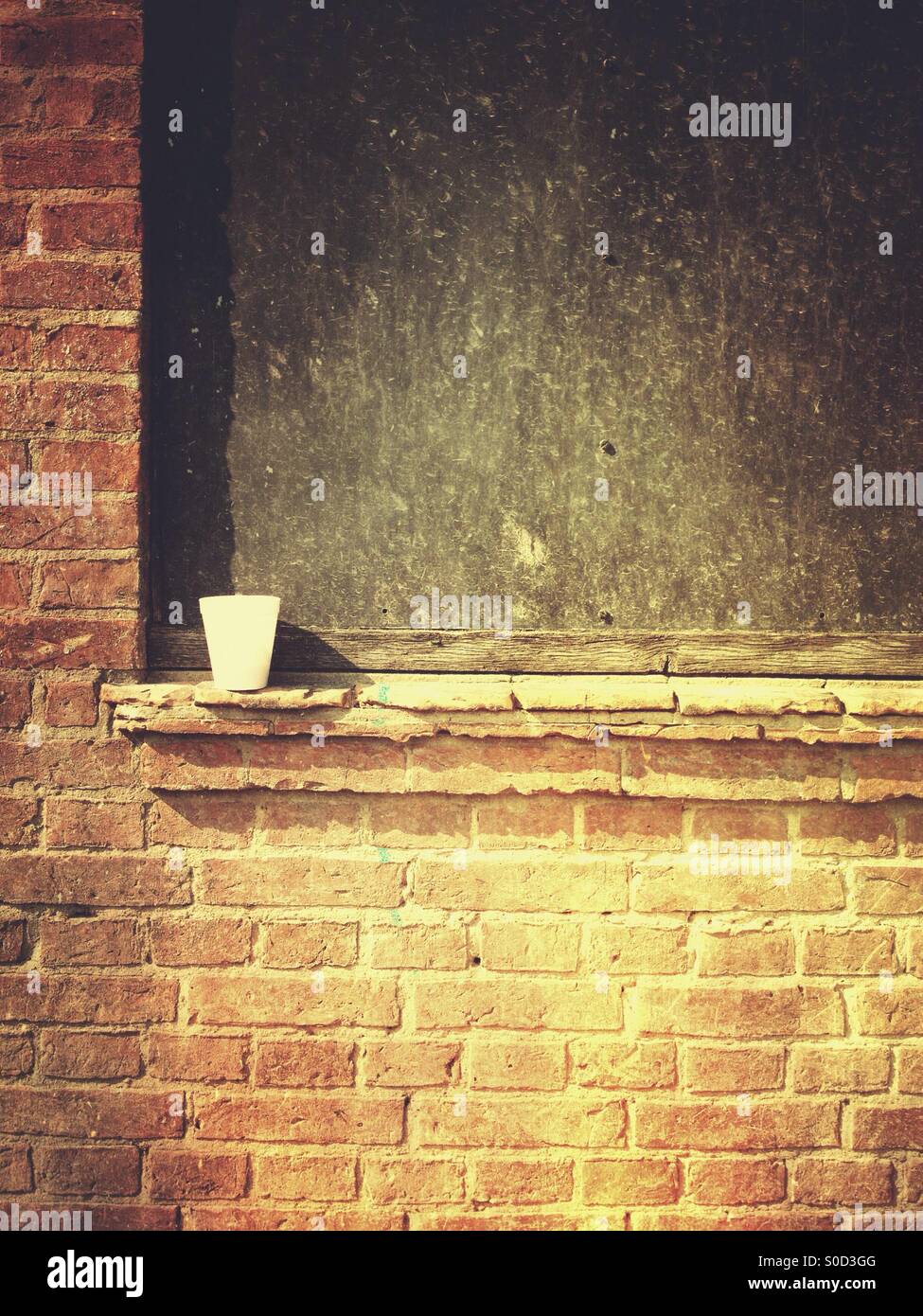 Isolated coffee cup on a wall - Smartphone Captured Stock Image