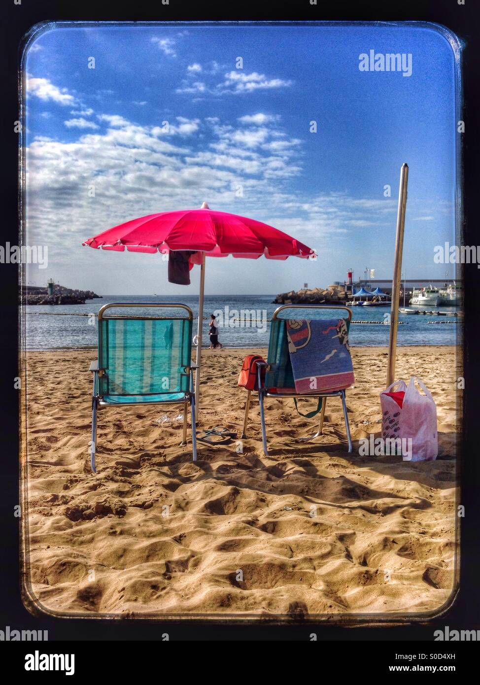 Red umbrella on the beach in Gran Canaria Stock Photo
