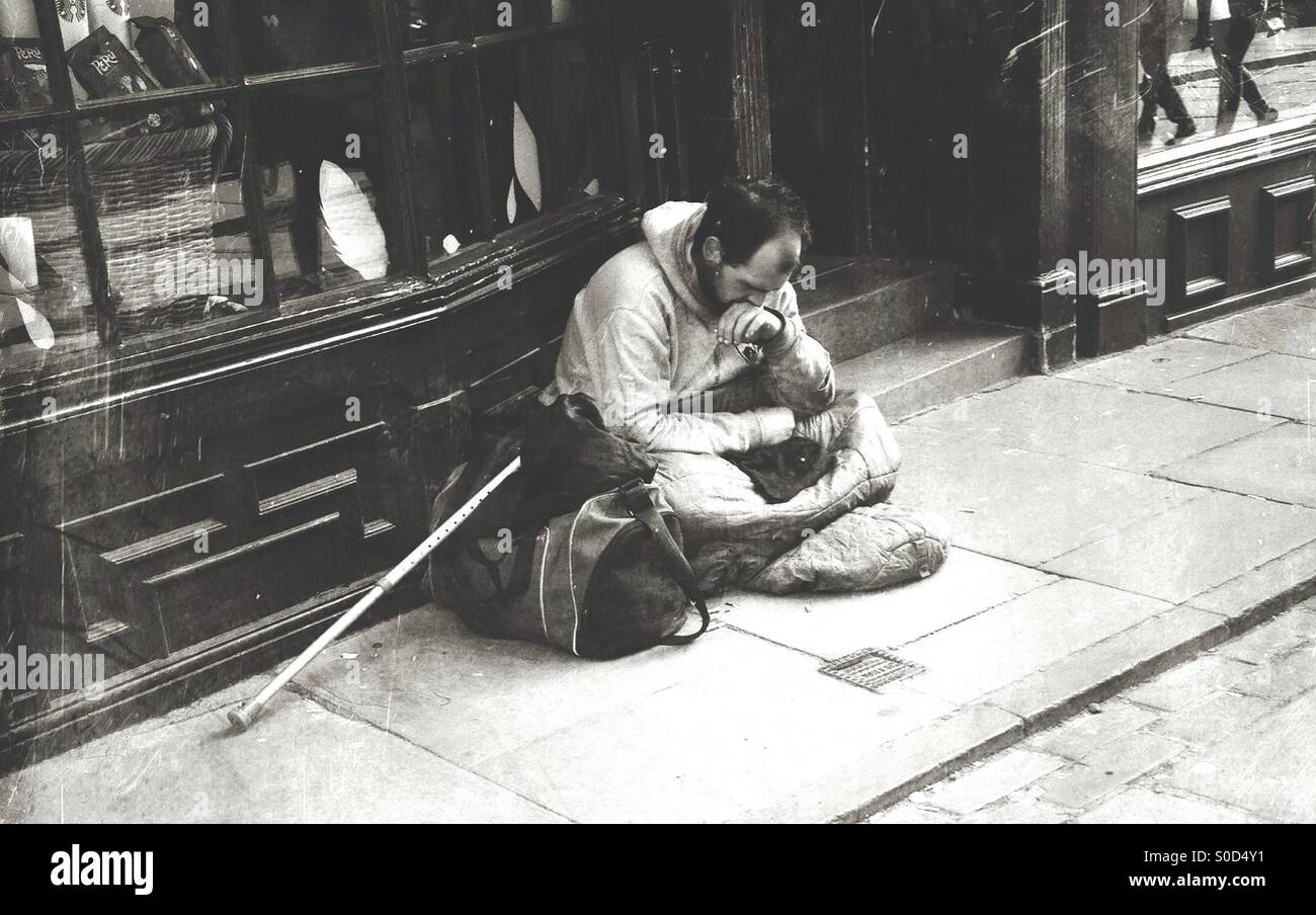 Homeless man near a shop doorway Stock Photo