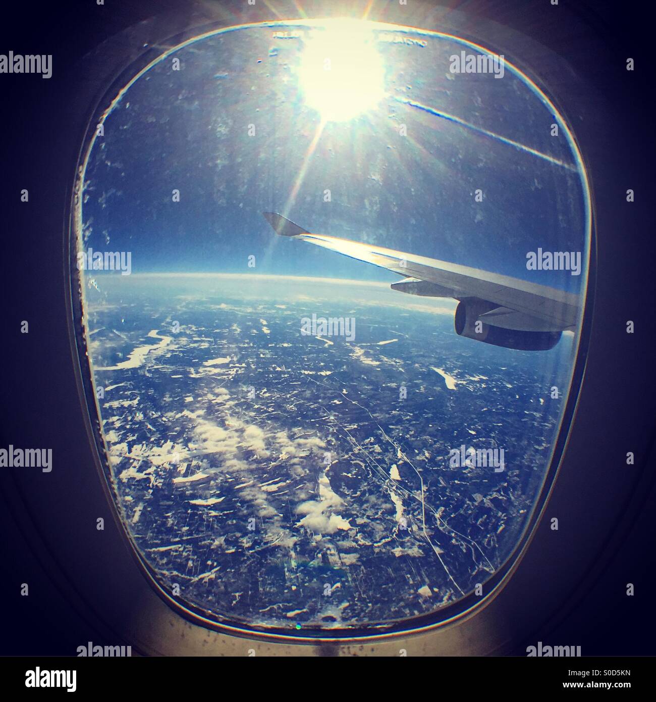 Sun shining through a plane window Stock Photo