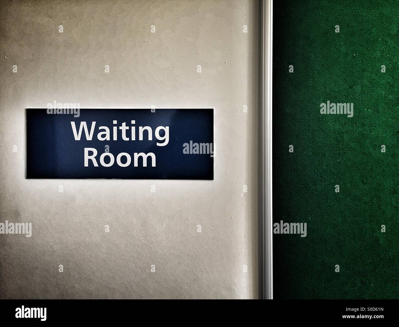 Waiting room sign on plain wall. Horizontal format with copyspace. Stock Photo