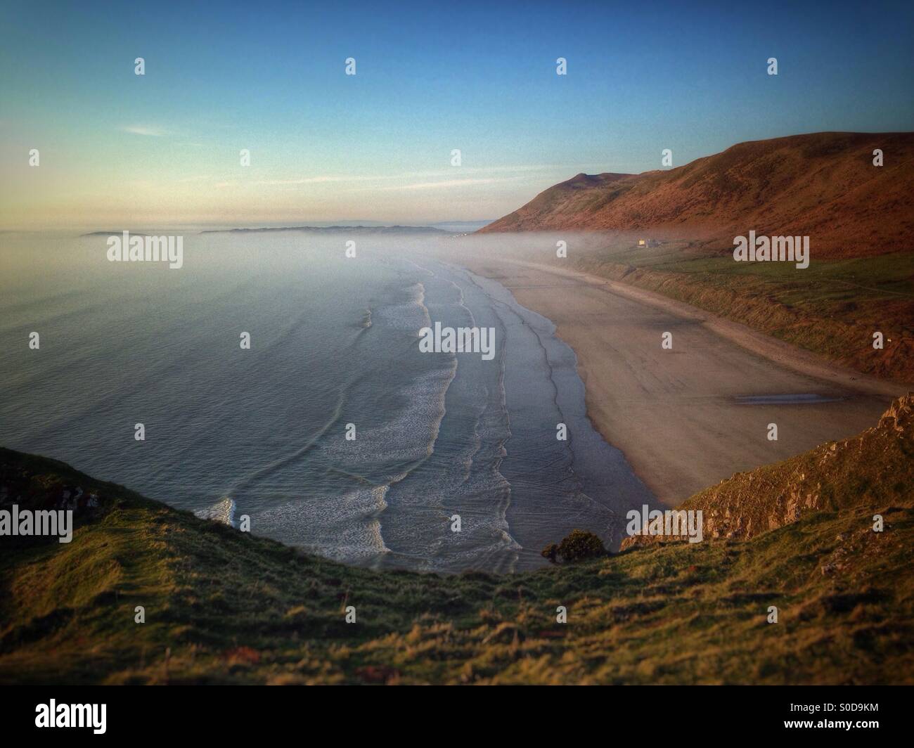 Sea mist rolling up Rhossili beach, Gower peninsula, Wales - Smartphone Captured Stock Image