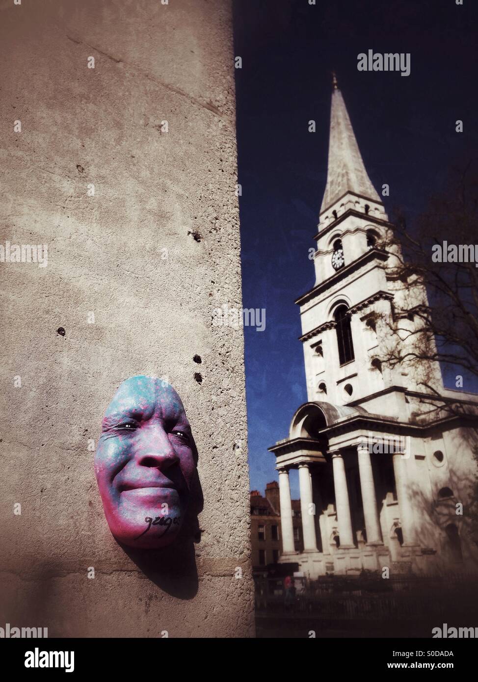 Face sculpture by French street artist Gregos with Christ Church Spitalfields in the background. Spitalfields, London. UK. Stock Photo