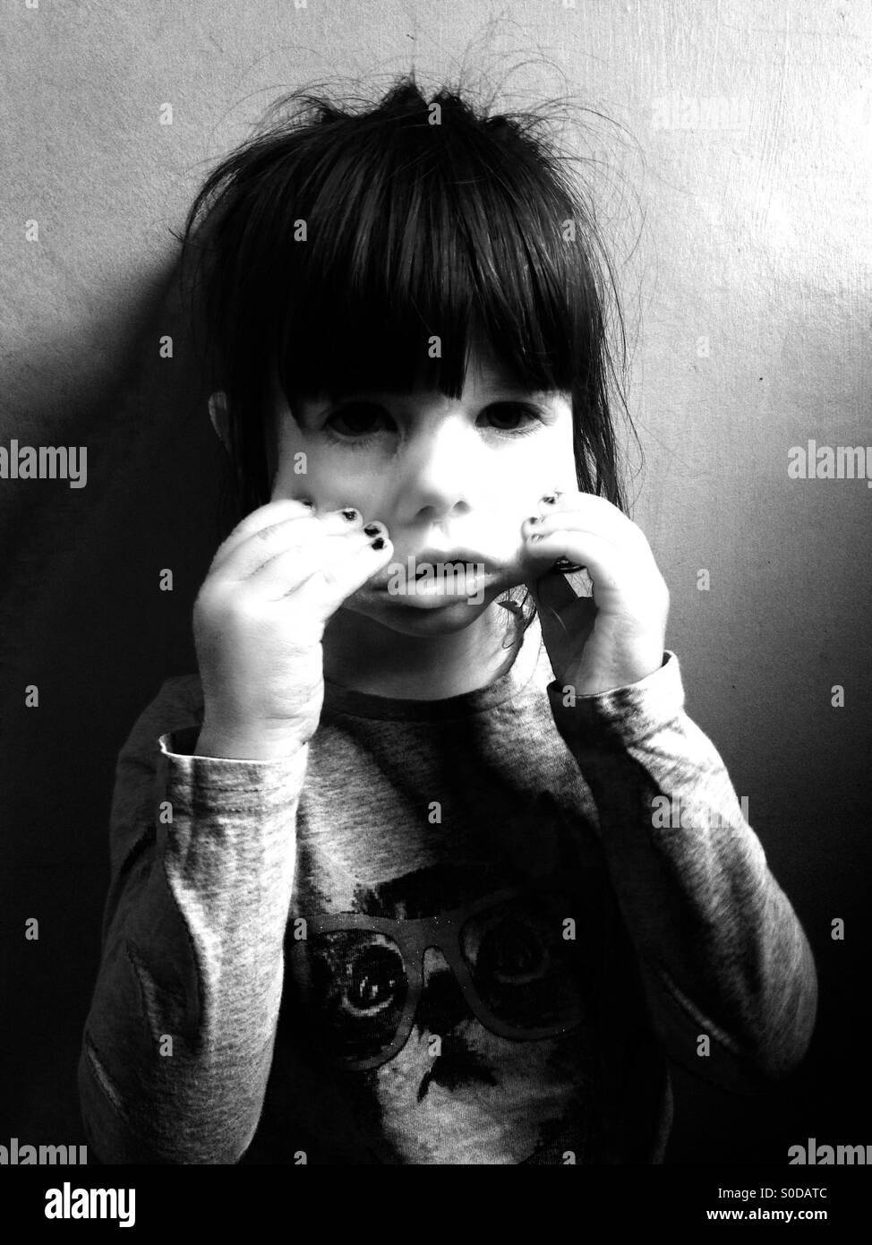 3-year old old girl pulling a scary face - Smartphone Captured Stock Image
