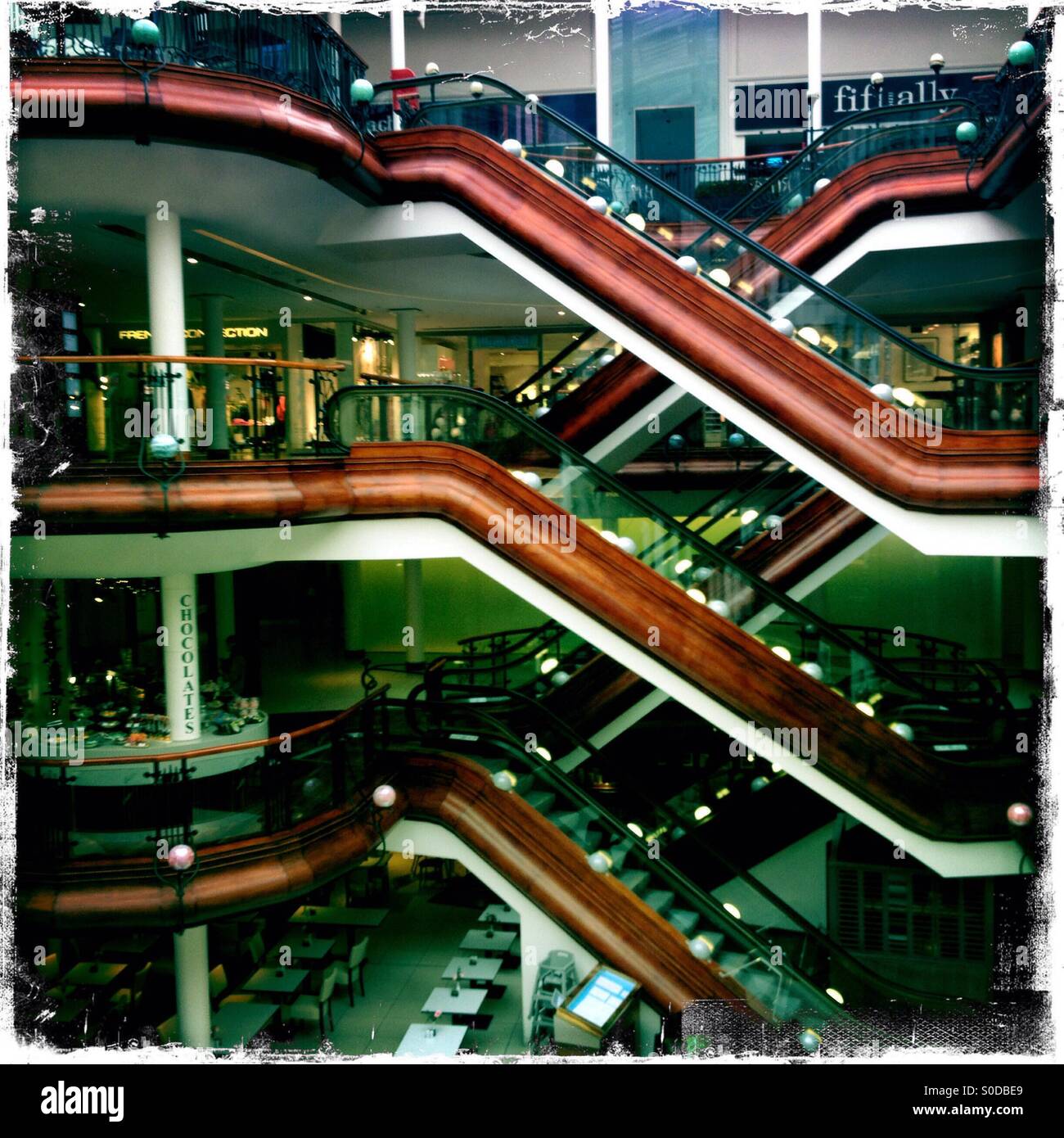 Pattern of escalators at the upscale Princes Square shopping centre Glasgow Scotland Stock Photo