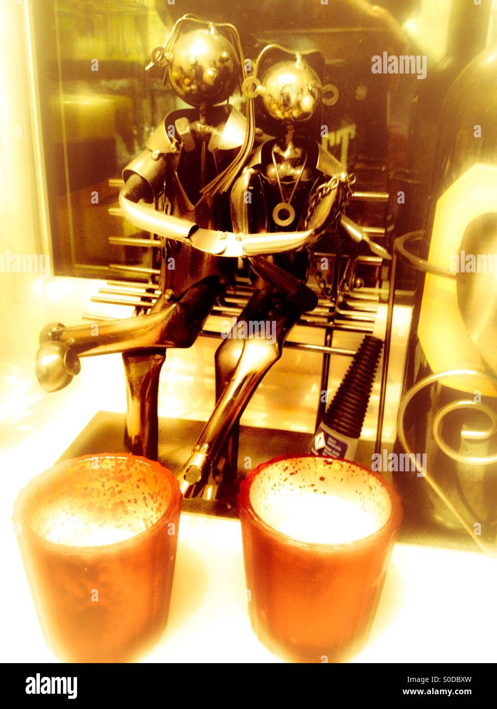 Nut and bolt man an woman sat on a bench Stock Photo Alamy