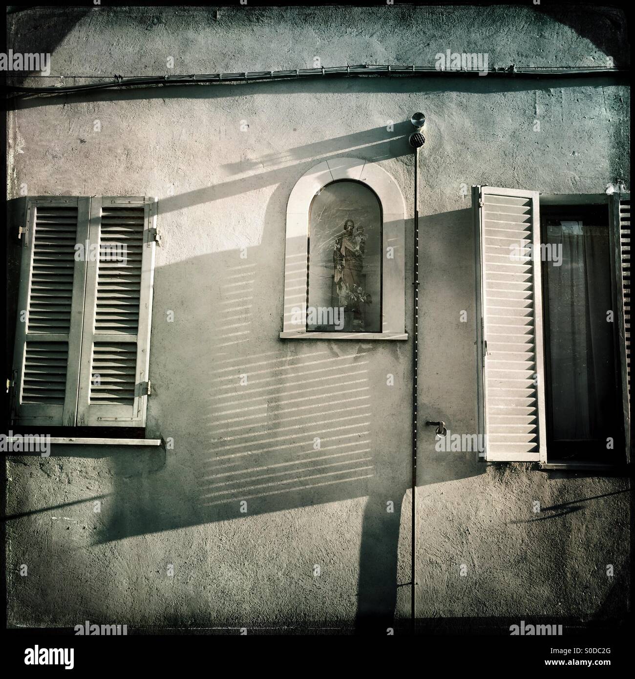 Holy image in a niche of a house in Italy - Smartphone Captured Stock Image